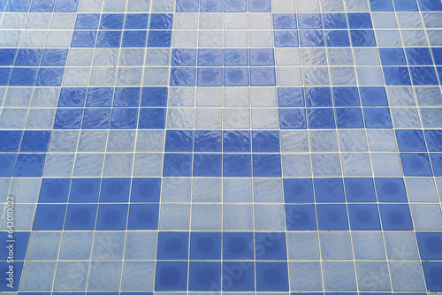 Blue mosaic tiled floor of swimming pool before water filling