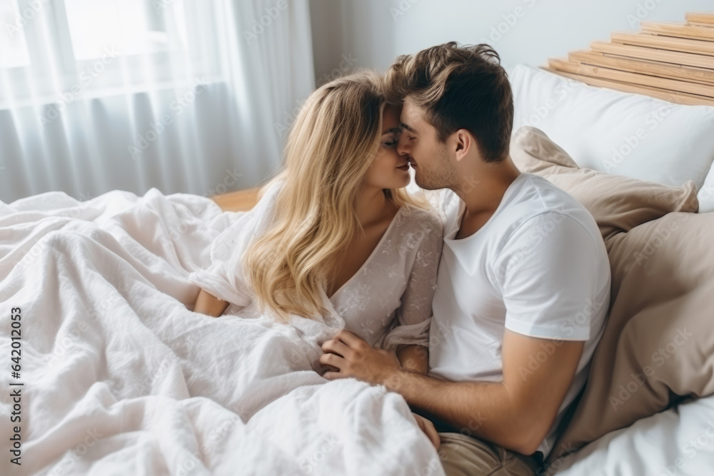 Lovers couple kissing in the bed , boyfriend and girlfriend intimate moments view - obrazy, fototapety, plakaty 
