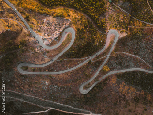 Espectacular vista aérea de una serpenteante carretera de montaña en Galicia que atraviesa el antiguo castro celta de Santa Tecla, en medio de un impresionante paisaje natural. photo