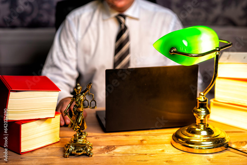 Valokuva office of a lawyer with statue of Lady Justice, goddess Justitia, on the desk