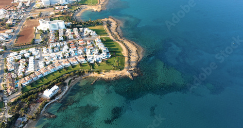 Drone shooting panorama of the coastline of the city with luxury hotels, villas, bays, ports with stylish yachts, sandy and rocky beaches and calm sea with clear blue water in Larnaca Cyprus photo