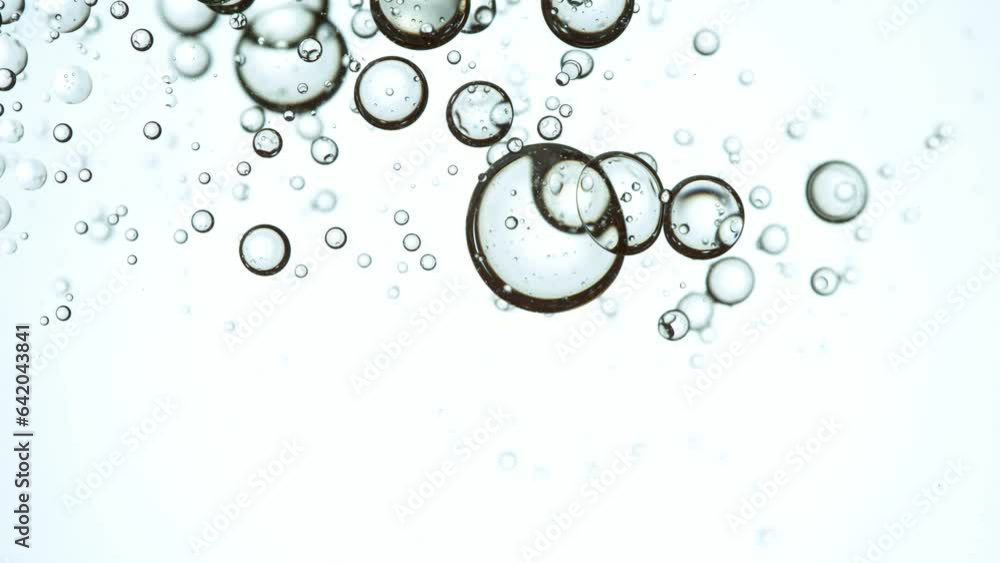 Super Slow Motion Shot of Oil Bubbles on White Background at 1000fps. Shoot on high speed cinema camera. Super Slow Motion Shot of Oil Bubbles on White Background at 1000fps. Shoot on high speed cinema camera.