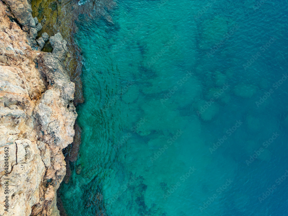 Aerial bird's eye view of cliffs and turquoise sea in Antalya Turkey