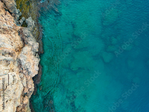 Aerial bird's eye view of cliffs and turquoise sea in Antalya Turkey