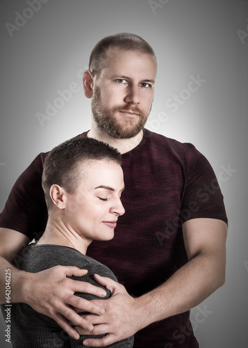 Portrait of attractive cute cheerful couple cuddling, Desaturated and toned image