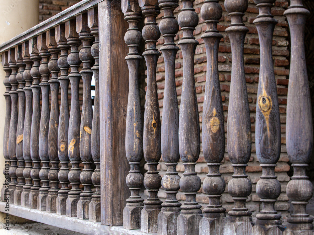 Traditional old wooden railings decorative pattern at old stone house in Geotgia