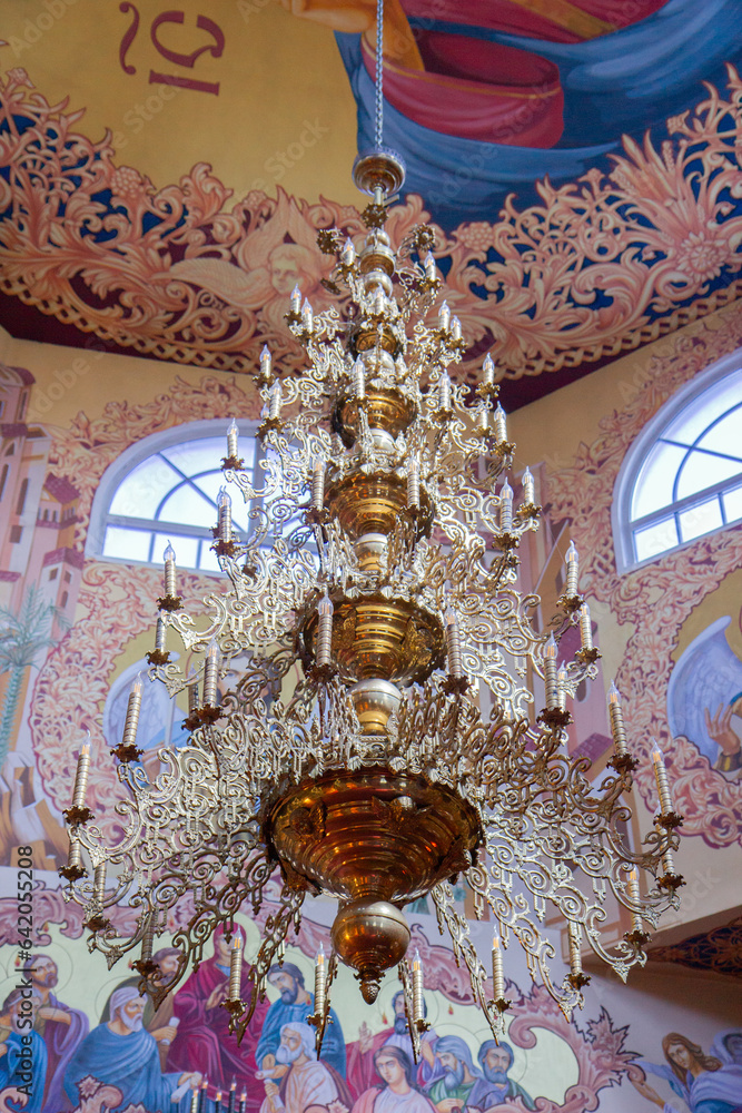 large chandelier with candles in the church, church interior