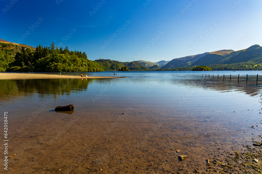 Fototapeta premium Reflections on a calm lake surrounded by mountains (Lake District, England)