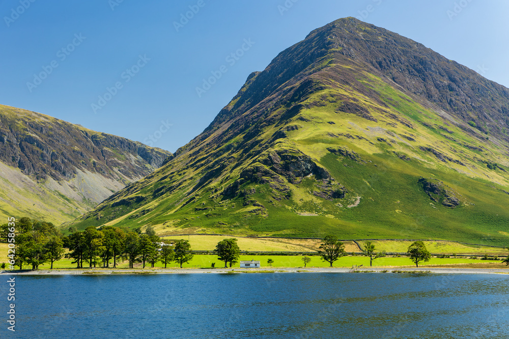 Calm waters of Buttermere with the tall mountain of Fleetwith Pike and the Honnister Pass behind (Lake District)