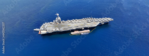Aerial drone ultra wide panoramic photo with copy space of latest technology nuclear powered aircraft carrier anchored in deep blue open ocean sea