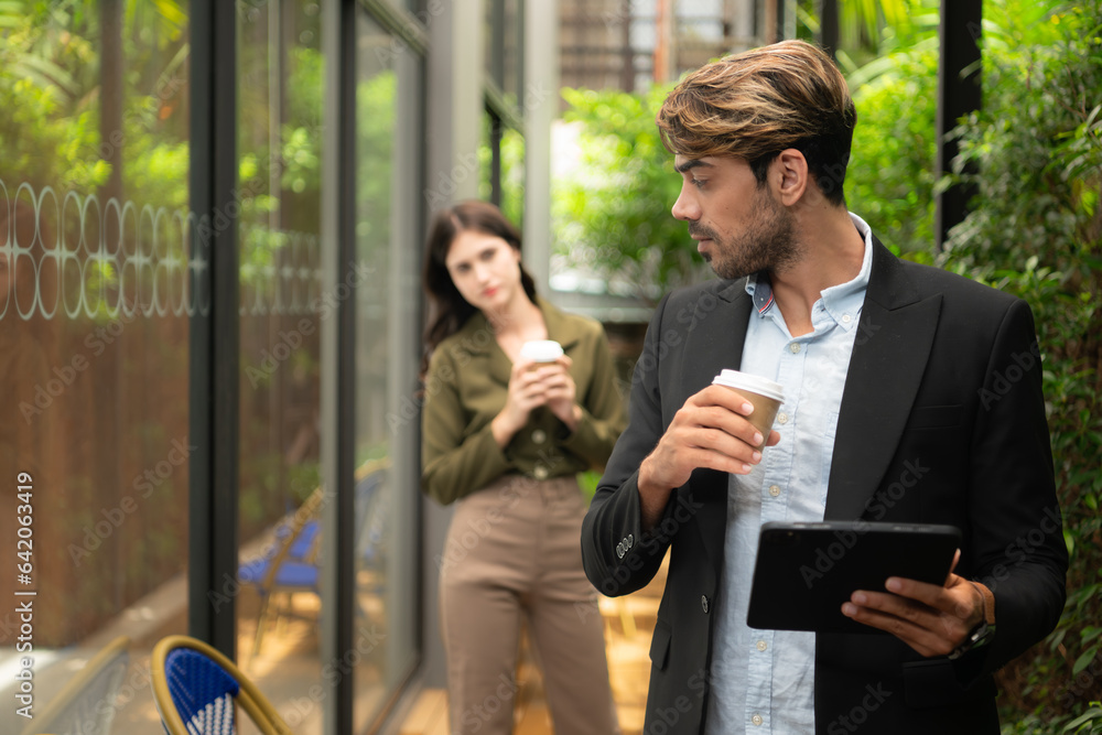 Both of businessperson using digital tablet at outdoor cafe. Business people meeting in coffee shop. Both of businessperson using digital tablet at outdoor cafe. Business people meeting in coffee shop.