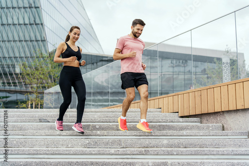 Physical education together, family couple healthy lifestyle. Instructors are a woman and a man in fitness running clothes. People workout trainer use fitness watch and app for exercise results.