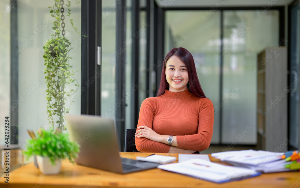 Businesswoman working attentively in front of laptop.Document review, analysis, and planning Businesswoman working attentively in front of laptop.Document review, analysis, and planning