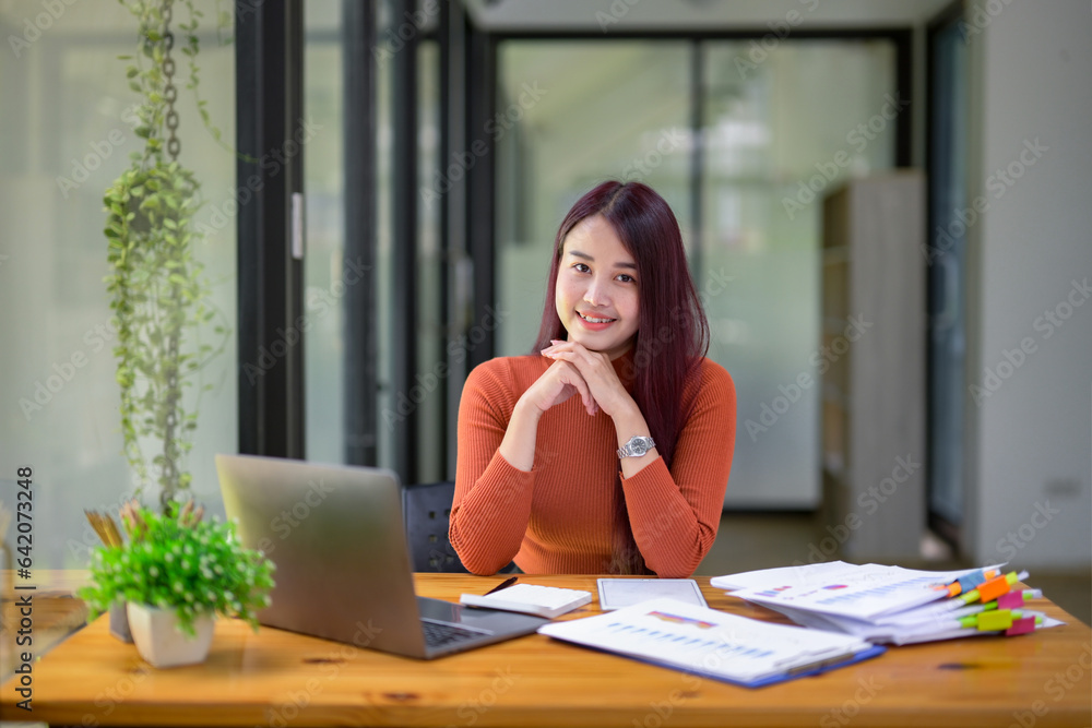 Businesswoman working attentively in front of laptop.Document review, analysis, and planning Businesswoman working attentively in front of laptop.Document review, analysis, and planning