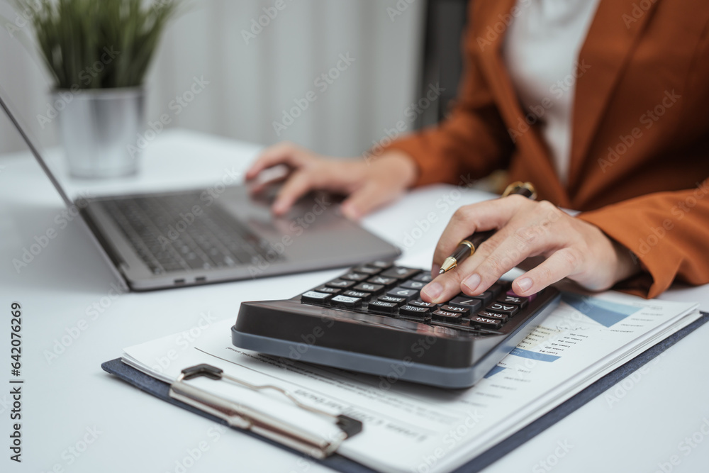Close up hands of woman in brown formal suit checking bills, taxes, bank account balance, using calculator, Personal Checking, Empower Checking, Personal Savings, Certificates, IRAs, Money Market Close up hands of woman in brown formal suit checking bills, taxes, bank account balance, using calculator, Personal Checking, Empower Checking, Personal Savings, Certificates, IRAs, Money Market