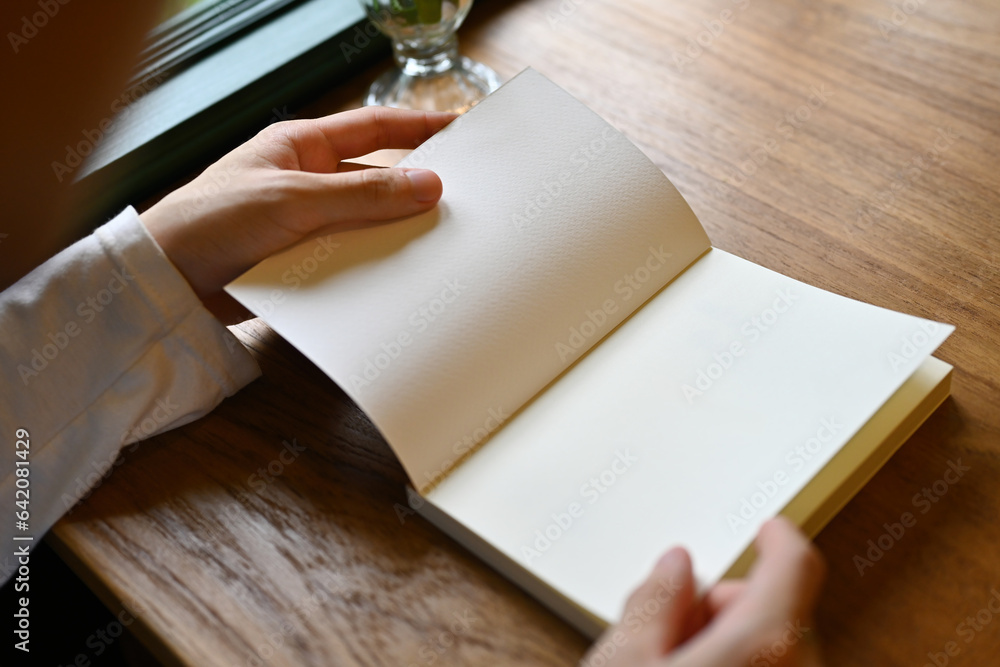 Close-up image of male hand open a empty page of book Close-up image of male hand open a empty page of book
