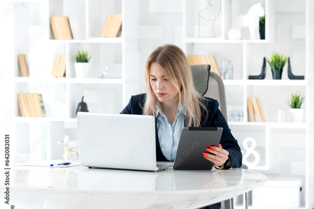 Serious business woman in black suit working in modern office Serious business woman in black suit working in modern office