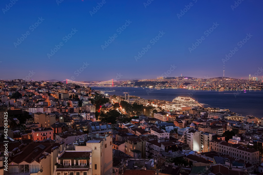 the sunset in Istanbul seen from the Galata Tower with the spectacle of the Red Bridge in the distance that unites the two continents