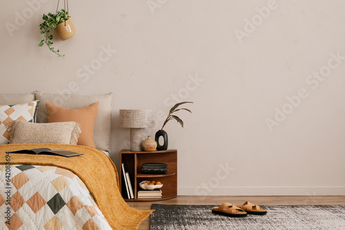 Canvastavla Minimalist composition of bedroom interior with copy space, bed, orange bedding, wooden bedside table, patterned rug, plants, stylish lamp, slippers and personal accessories