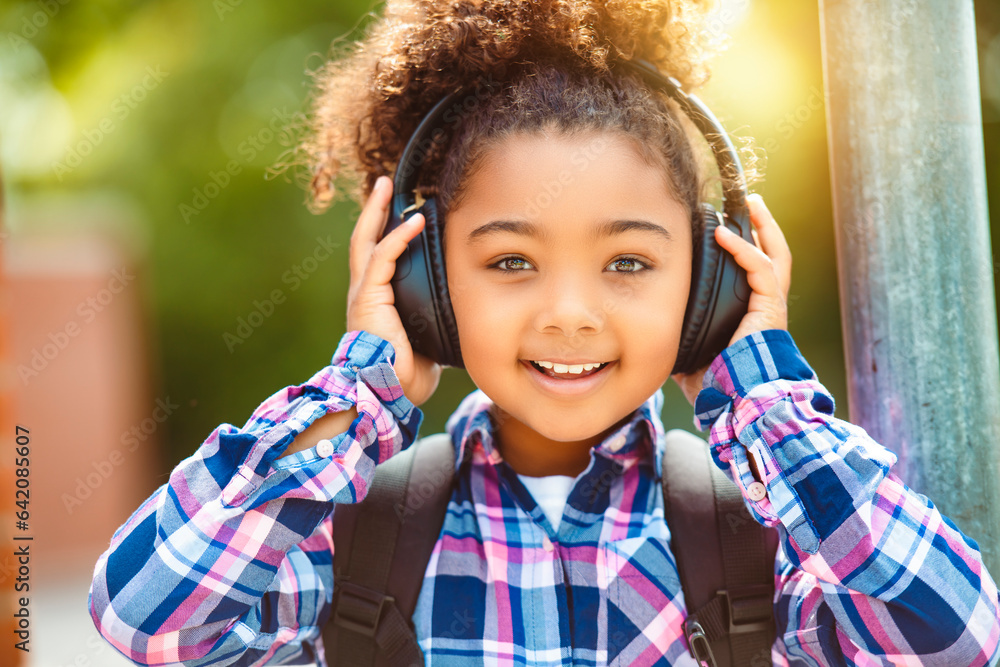 child going back to school with a backpack listening music child going back to school with a backpack listening music