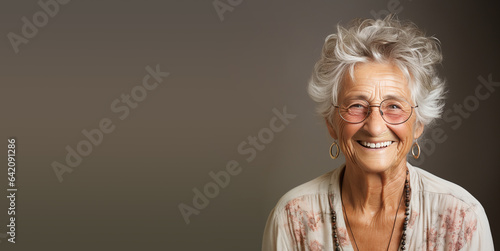 Portrait of a happy old woman with eyeglasses, smiling face, pensioner with white hair, clean studio background