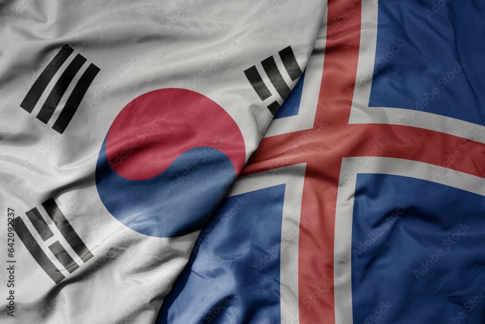 Fototapeta premium big waving national colorful flag of south korea and national flag of iceland .
