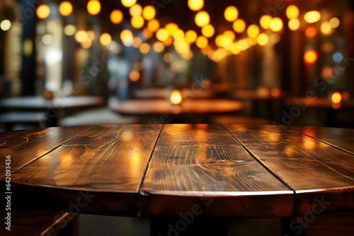 Empty wooden table and pub or bar blur background with bokeh light © Planetz