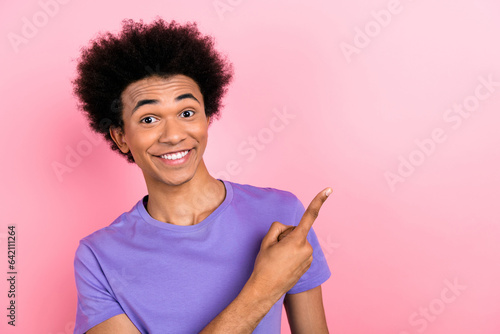 Photo of positive satisfied man wear stylish purple clothes arm direct empty space novelty ad isolated on pink color background
