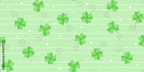 Green shamrocks and clover leaves with black edging on a pale green striped background with dots. St. Patrick's Day endless texture. Vector seamless pattern for festive wrapping paper, cover and print