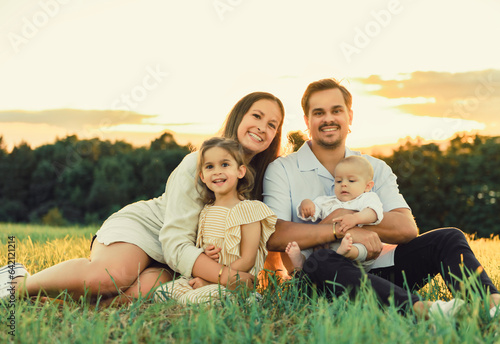 Happy family with baby boy on nature sunset © Louis-Photo