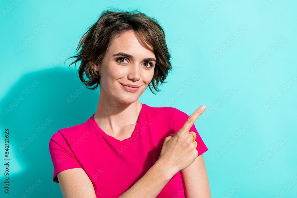 Photo of cute satisfied girl wear pink summer outfit arm demonstrate positive feedback blank space isolated on cyan color background Photo of cute satisfied girl wear pink summer outfit arm demonstrate positive feedback blank space isolated on cyan color background