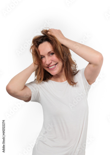 Happy mature woman laughing standing isolated on white background. Smiling confident cheerful middle aged 50s lady with dental white smile looking at camera, copy space.