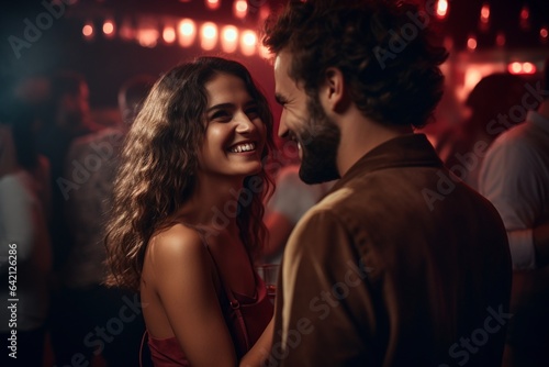 couple in love laughing and smiling in nightclub