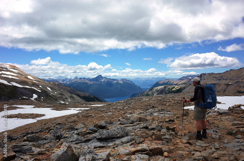 Solo hiking in Patagonia Nahuel Huapi National Park, Argentina, Nature of South America, Man trekking high altitude mountain under clouds on rocks and snow