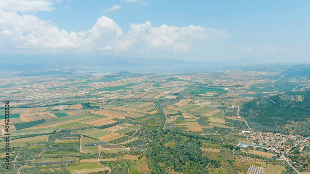 Lamia, Phthiotis, Greece. Panorama of the valley with fields. Olive trees, colorful fields. Summer, Cloudy weather, Aerial View