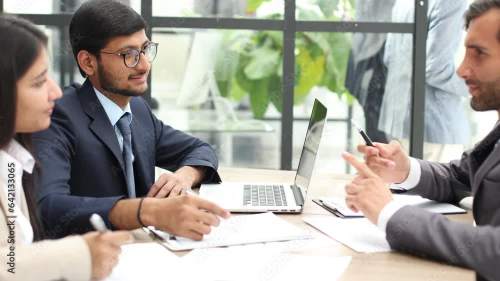 Business people working at desk by windows