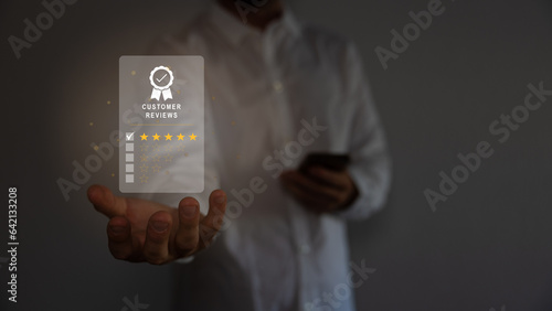 customer service evaluation and feedback rating. costumer review concept, man using phone chooses happy smiling face 