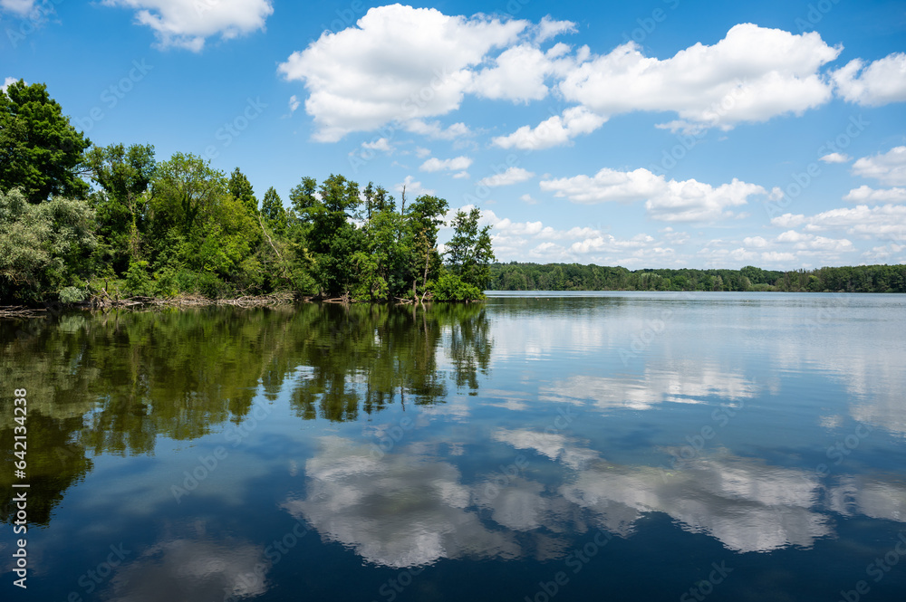 Reflecting trees and clouds in the Krickenbecker See, Viersen, Germany