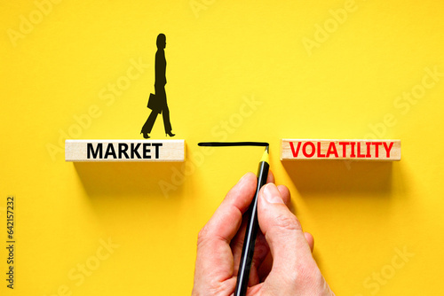 Market volatility symbol. Concept words Market volatility on beautiful wooden blocks. Beautiful yellow table yellow background. Businessman hand. Business market volatility concept. Copy space.