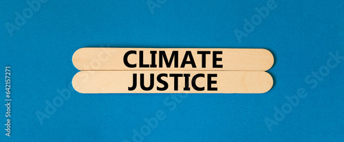 Climate justice symbol. Concept words Climate justice on beautiful wooden stick. Beautiful blue table blue background. Business environment climate justice concept. Copy space.