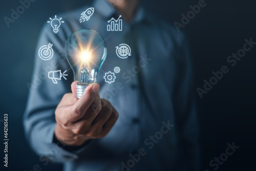 business, document, management, file, search, solution, light bulb, target, network, process. close up to hand, hold light bulb to light up solution and advertise to hit the goal and target.