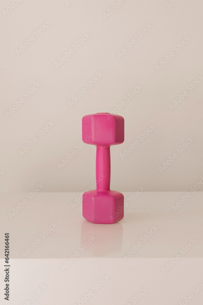 Pink dumbbell on white Pink dumbbell on white