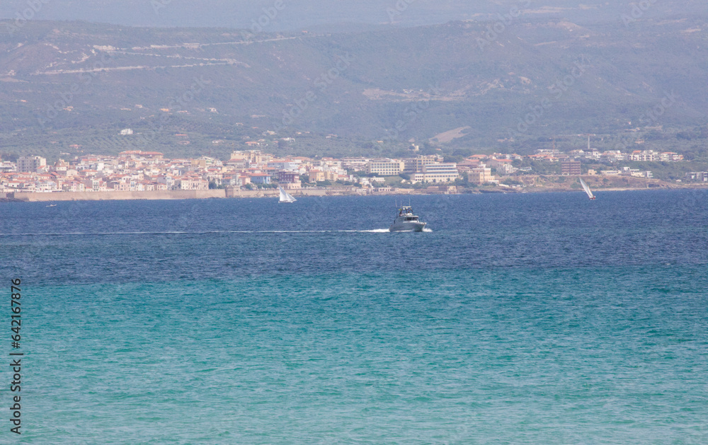Distant boat on blue Sardinian sea and mountain view