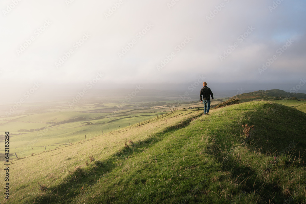 A man exploring a mountainside with a mazing views