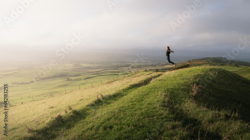 A man jumping on top of a mountain
