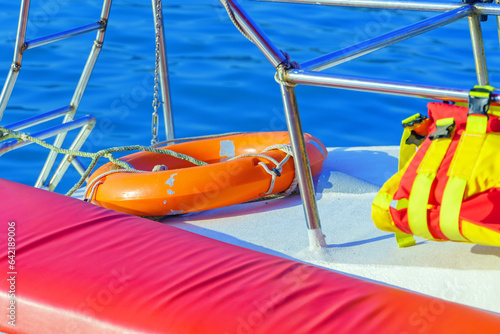 фотографія Plastic lifebuoy and life jacket on board a pleasure yacht