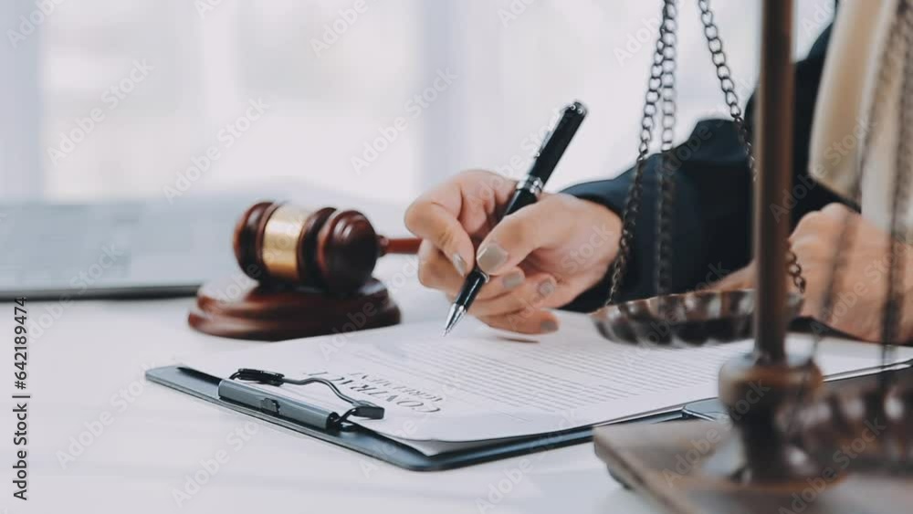 Business and lawyers discussing contract papers with brass scale on desk in office. Law, legal services, advice, justice and law concept picture with film grain effect Business and lawyers discussing contract papers with brass scale on desk in office. Law, legal services, advice, justice and law concept picture with film grain effect