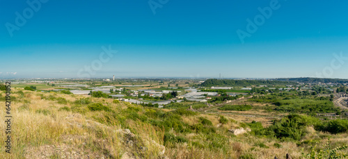 Panorama. Daytime landscape of the surroundings of the ancient city of Perge from a high point. Agricultural fields near the city of Perge in the province of Antalya  T  rkiye.