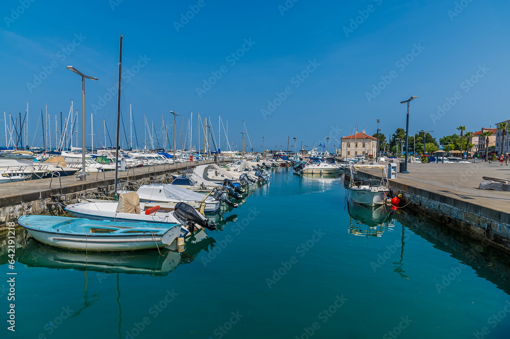 A view past boats moored in the harbour at Koper, Slovenia in summertime