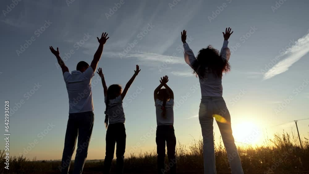 Happy family raise hands up overlooking setting sun. Concept of movement and harmony in relation to relatives. Scenic view of environment slow motion Happy family raise hands up overlooking setting sun. Concept of movement and harmony in relation to relatives. Scenic view of environment slow motion